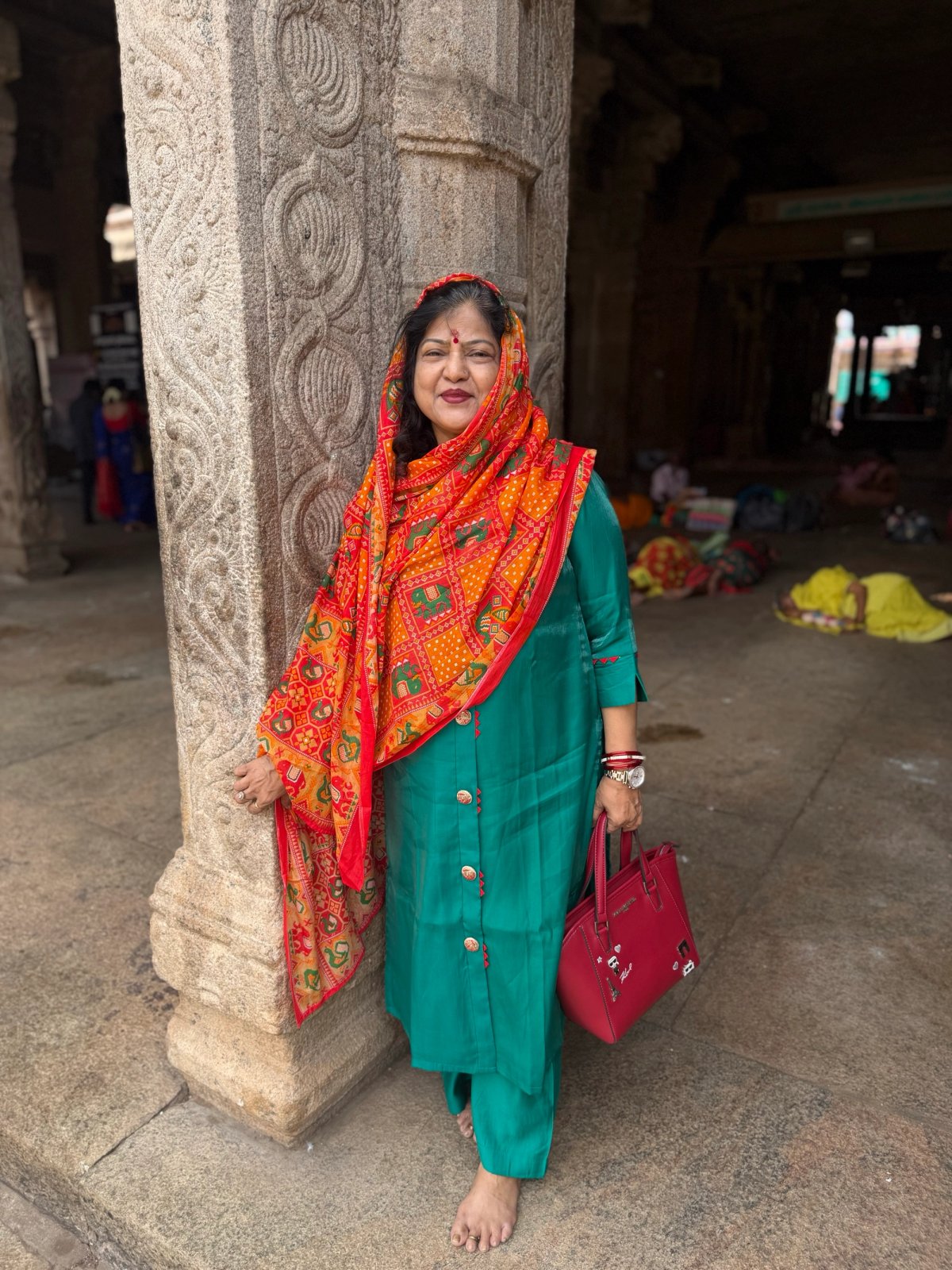 Ma against one of the carved pillars in the mandapam