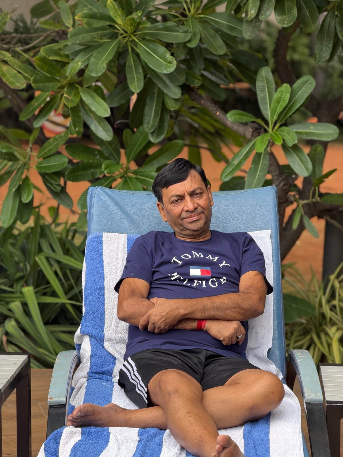 By the pool, under the frangipani