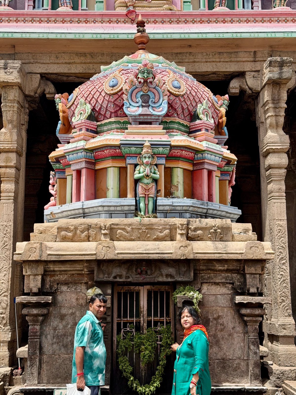 Under the Hanuman shrine, garlands on the door