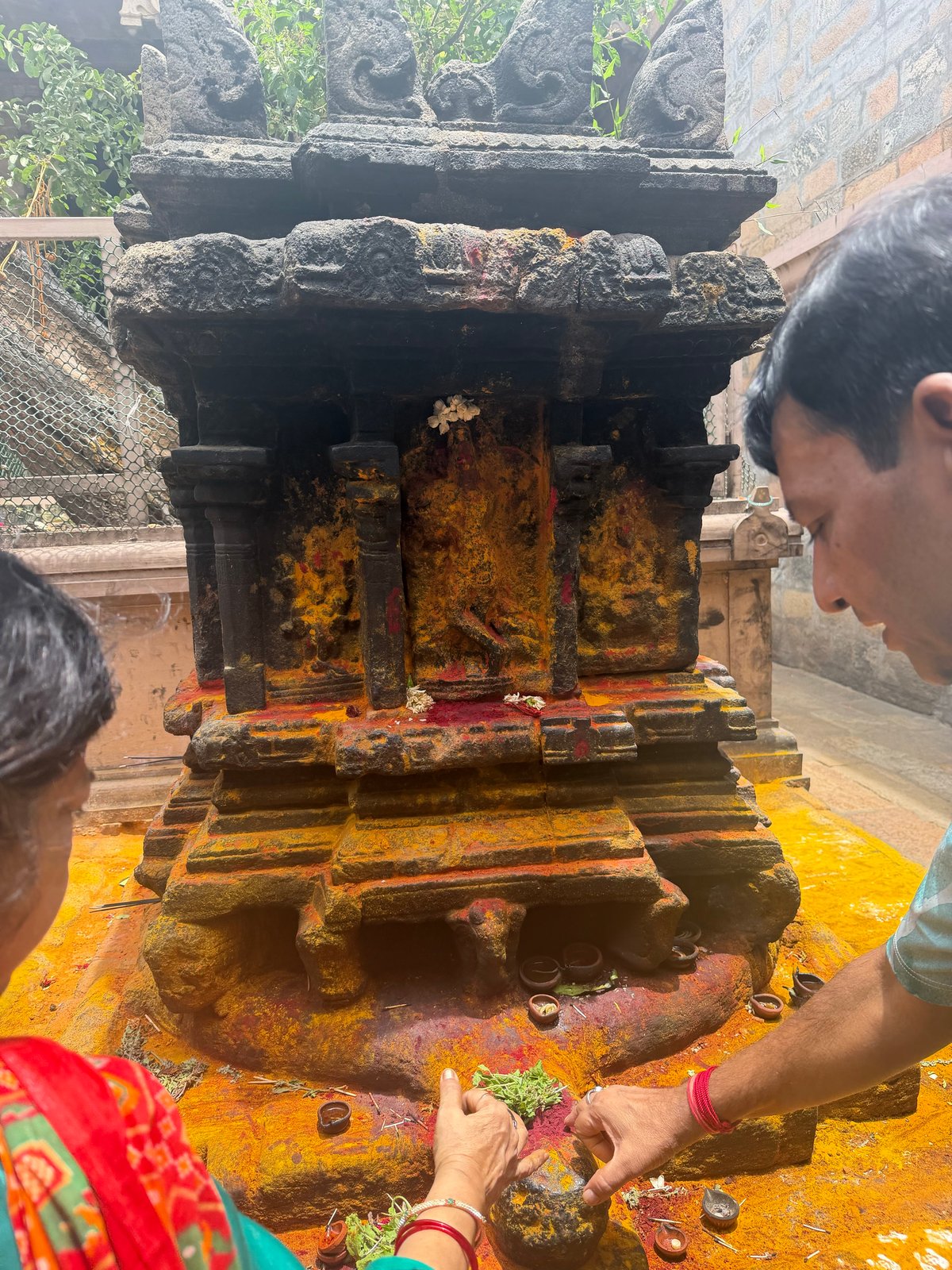Turmeric and flowers at the small shrine