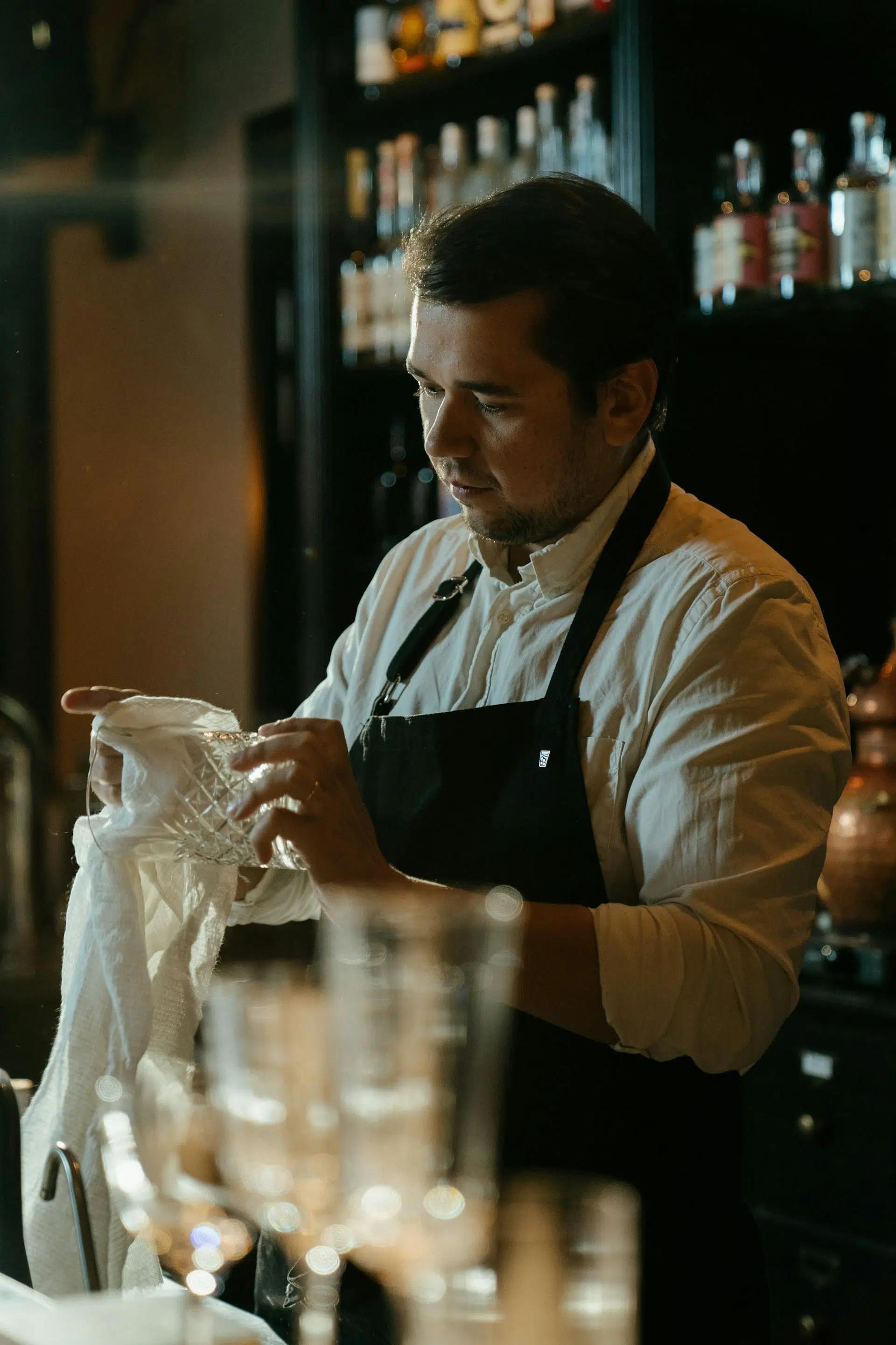 A bartender wiping a glass