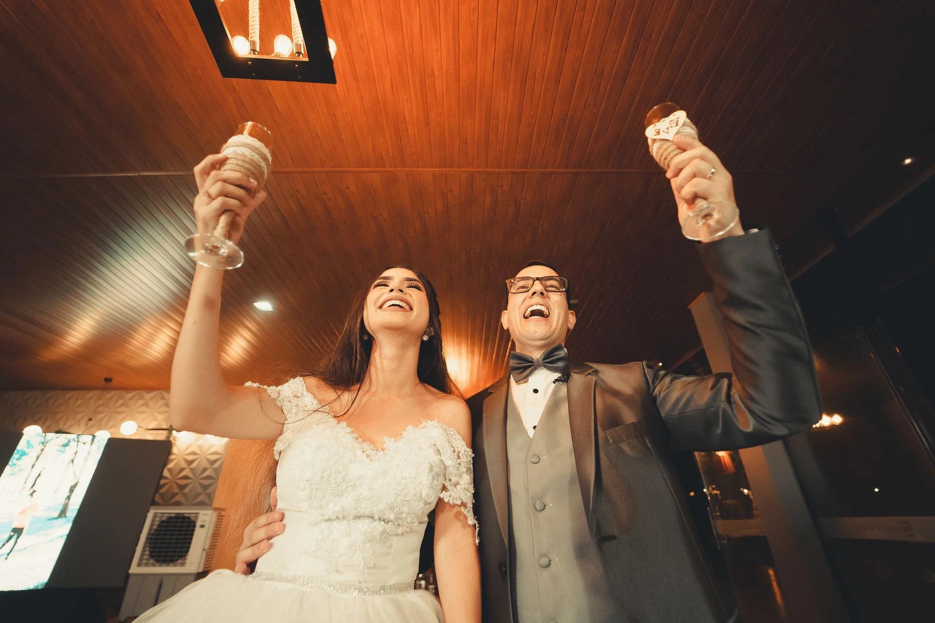 A happy bride and groom make a toast at their wedding reception