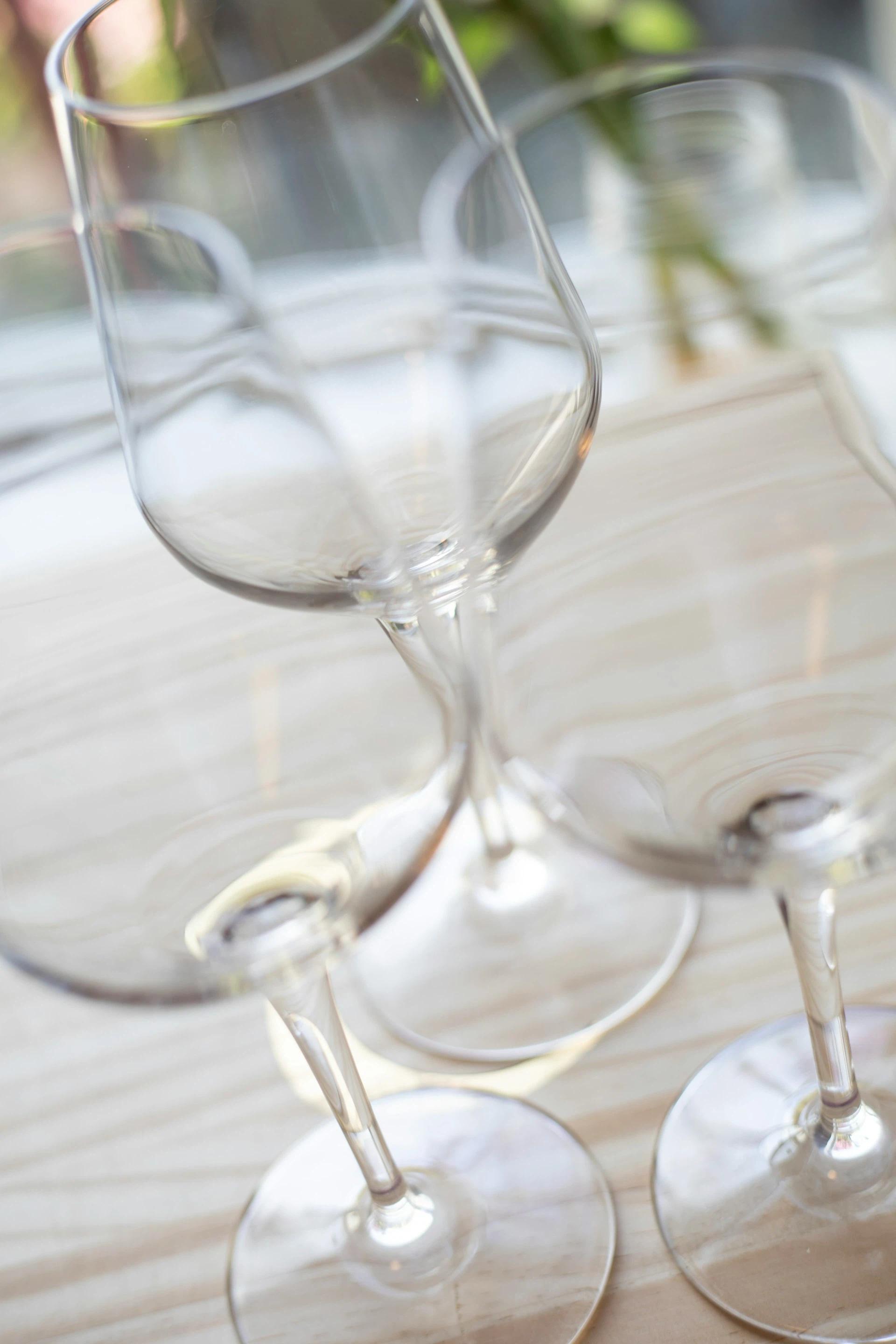 Three empty wine glasses on a table
