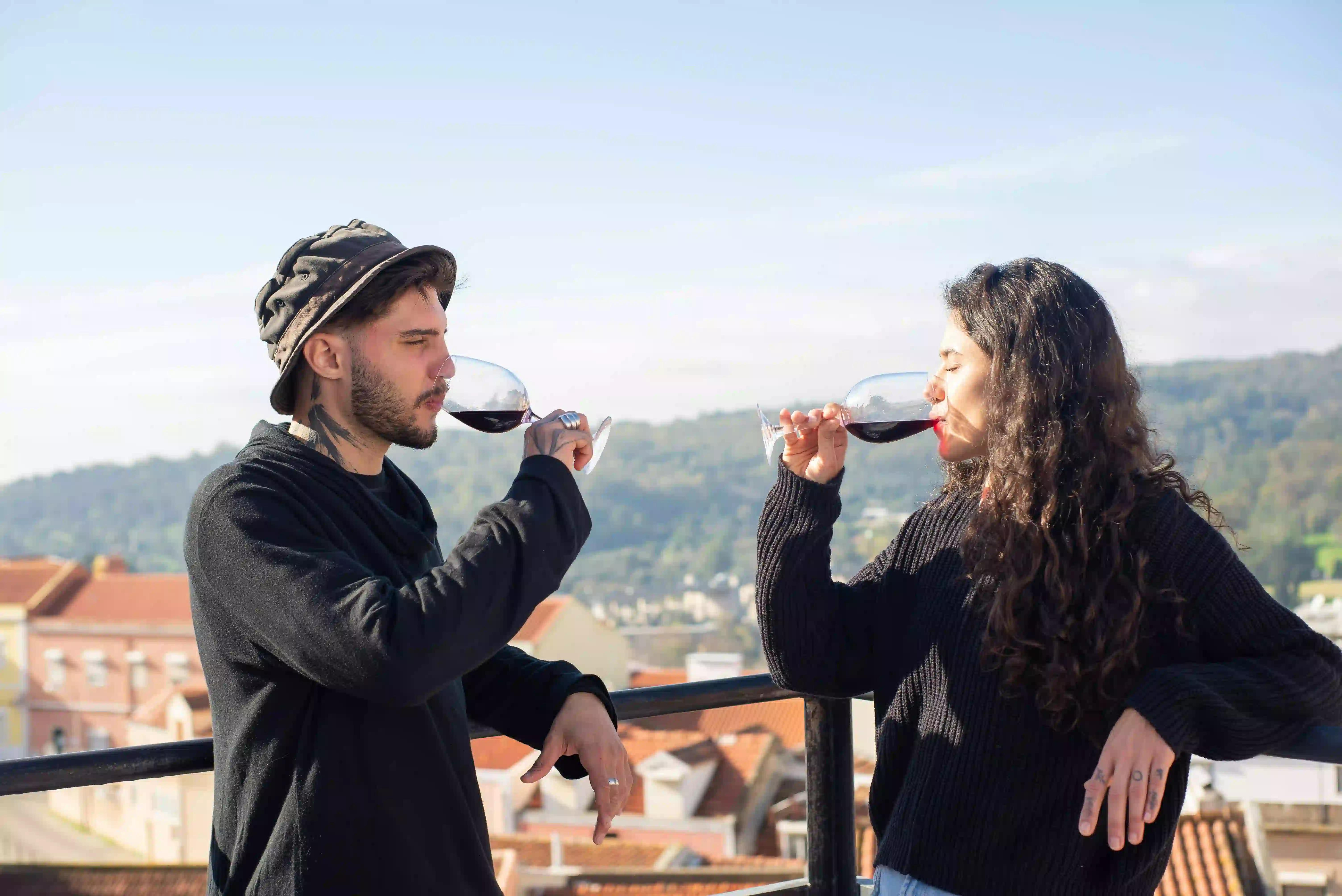 Two people drinking red wine