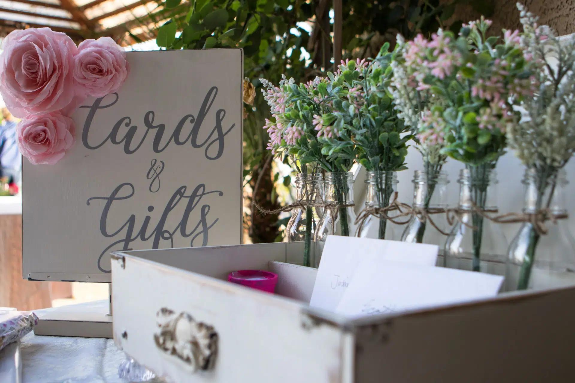 Beautifully decorated wedding card and gift station with floral arrangements and vintage style 