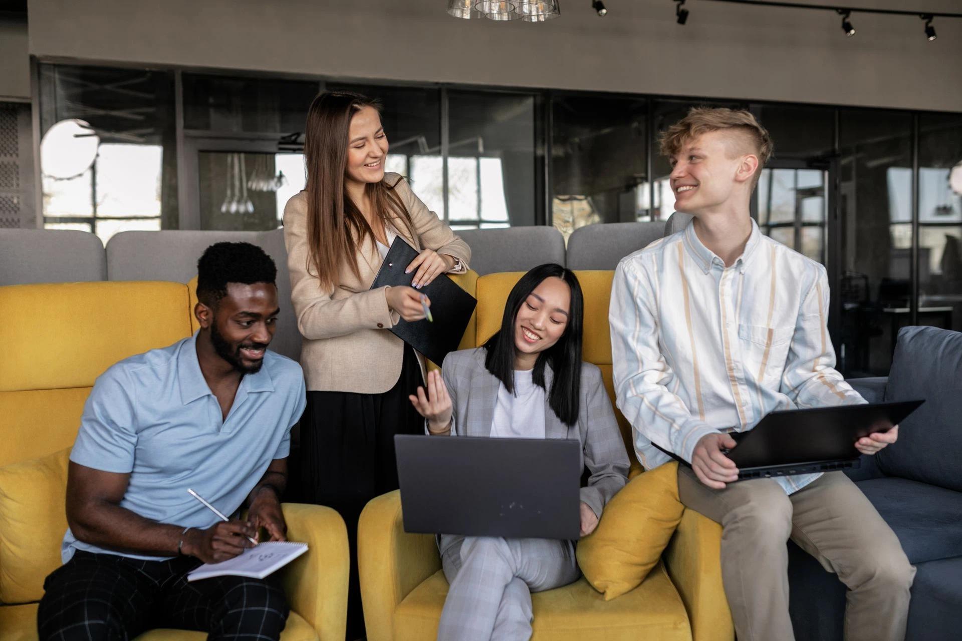 A diverse group of young professionals collaborating in a modern office setting