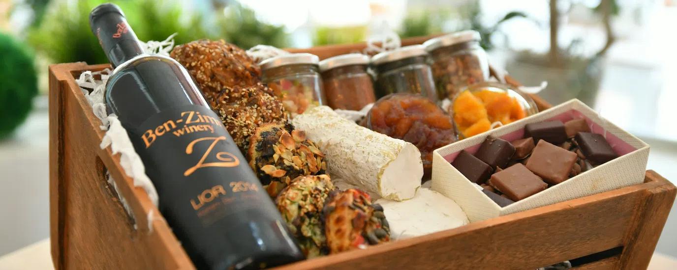 A gourmet food crate featuring wine and artisan food products 