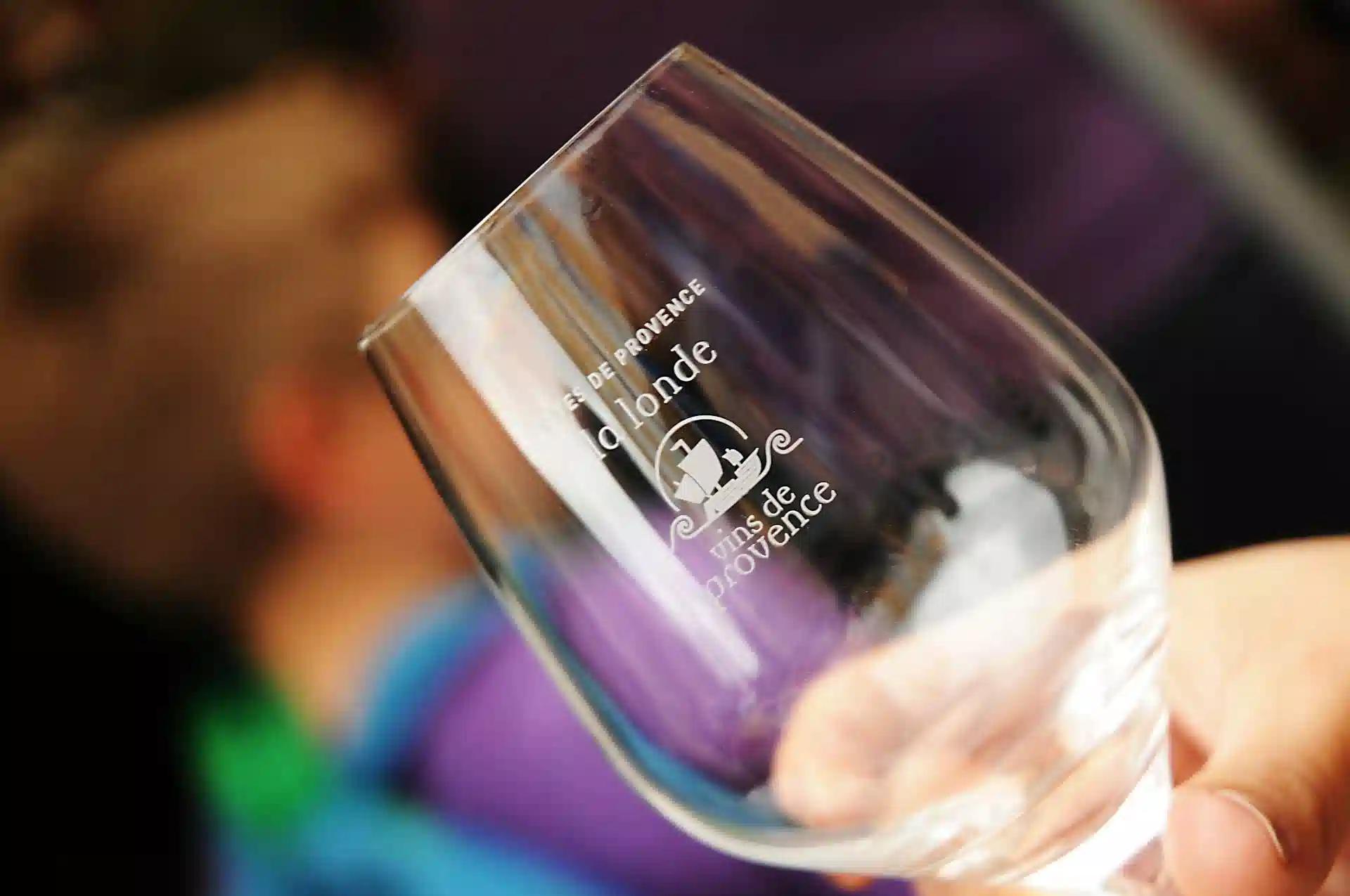 A closeup shot of an empty wine glass with engraving on the bowl