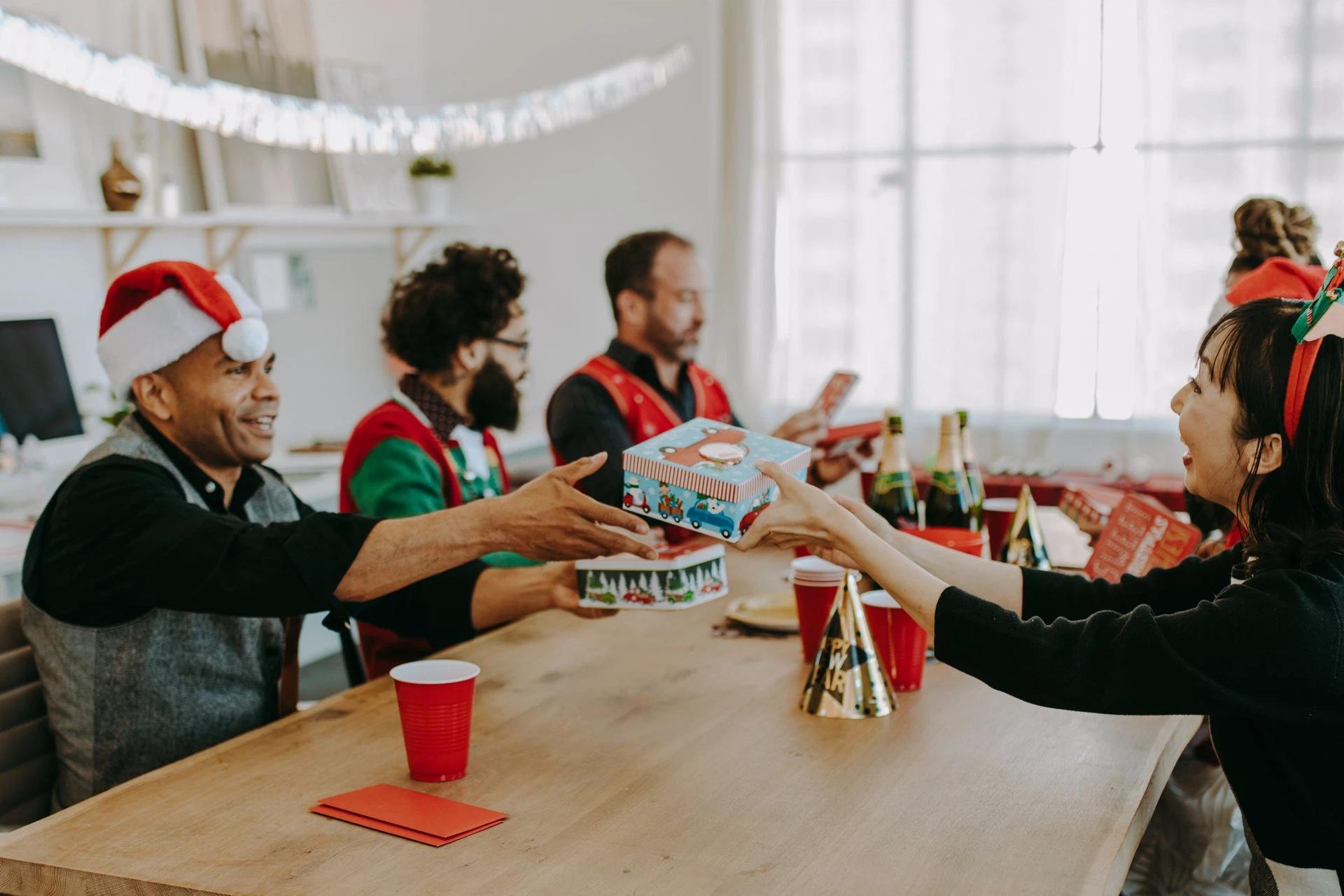Officemates exchanging gifts during a Christmas party