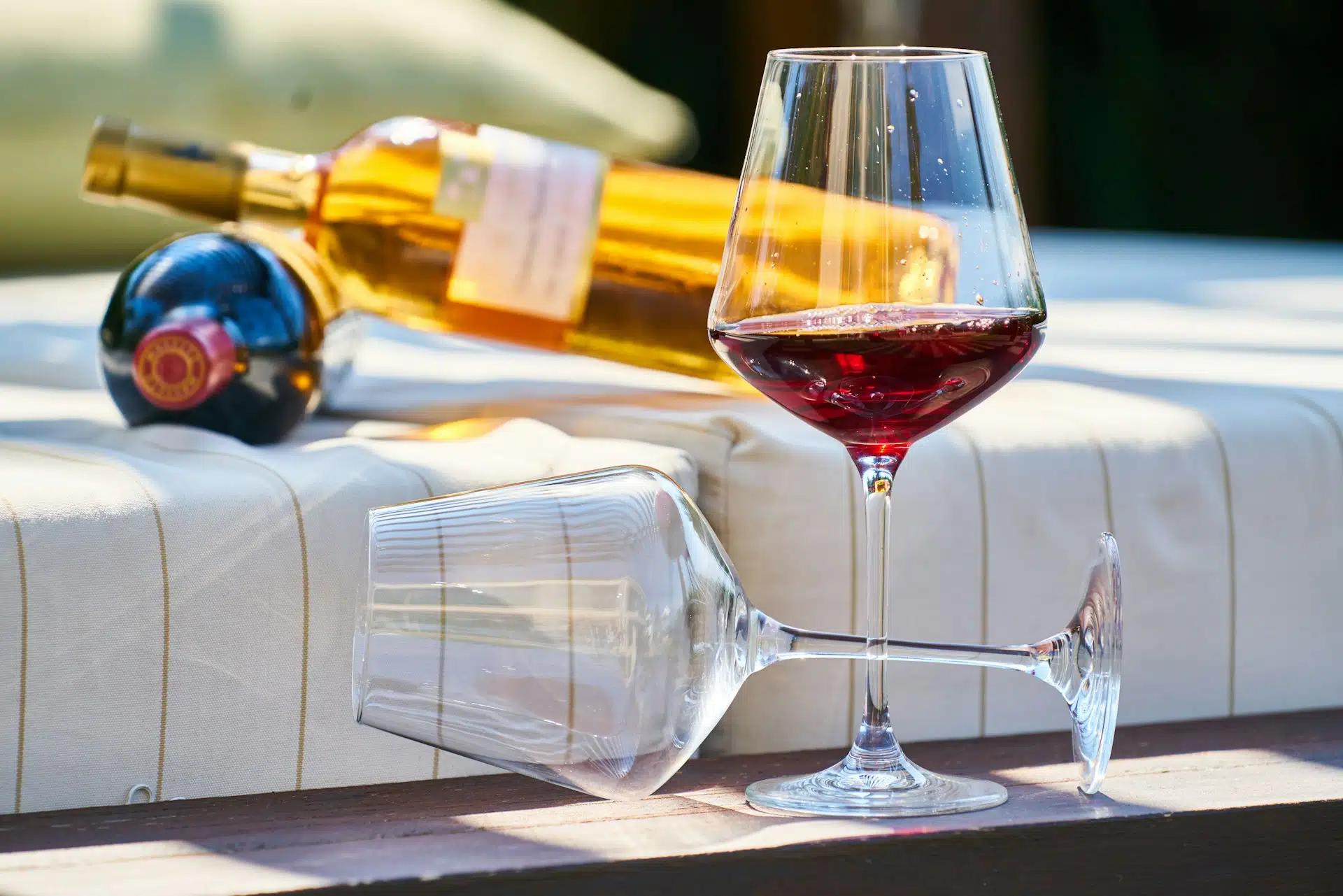 Two wine glass on the foreground and two wine glasses on the background