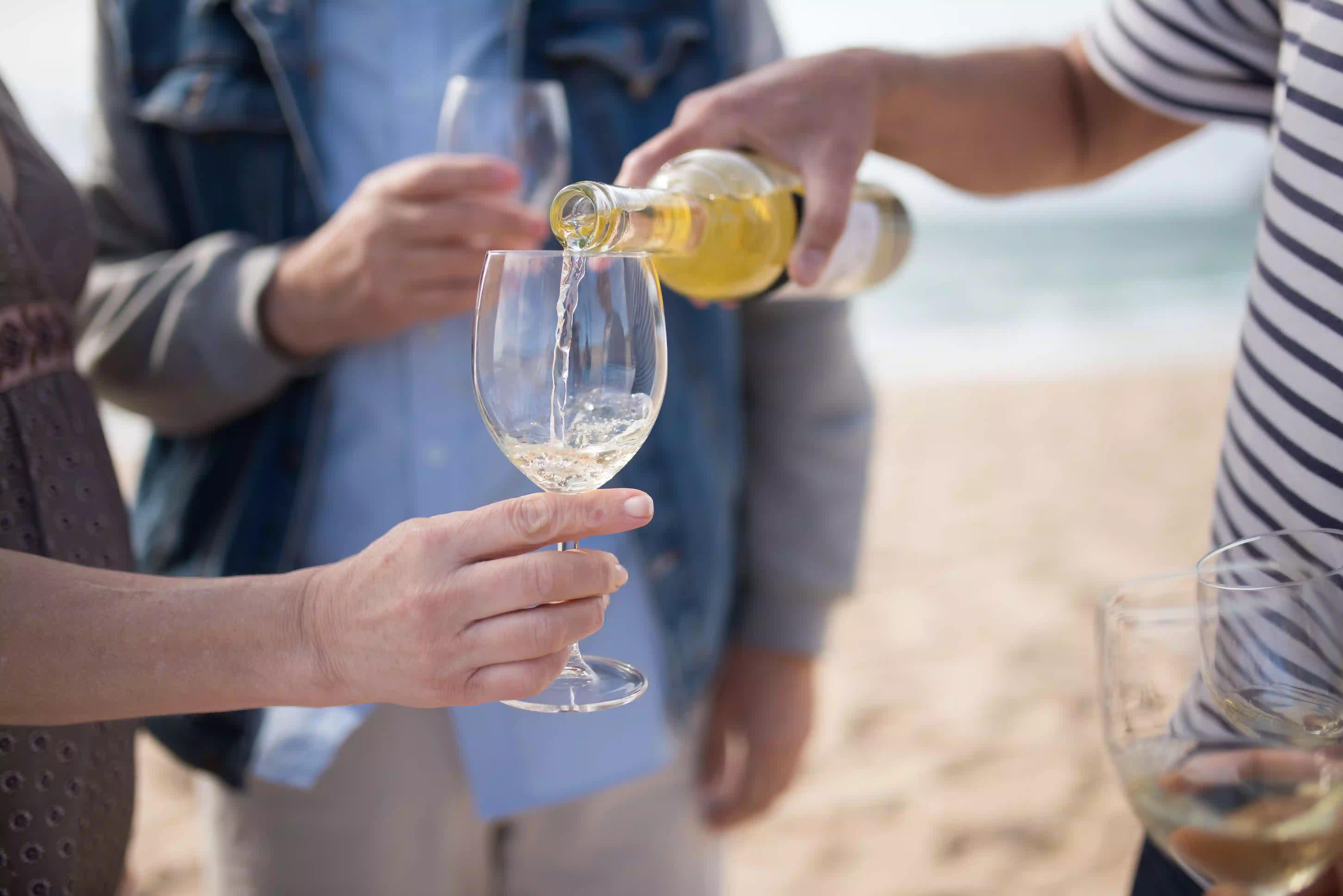 Pouring white wine into a glass