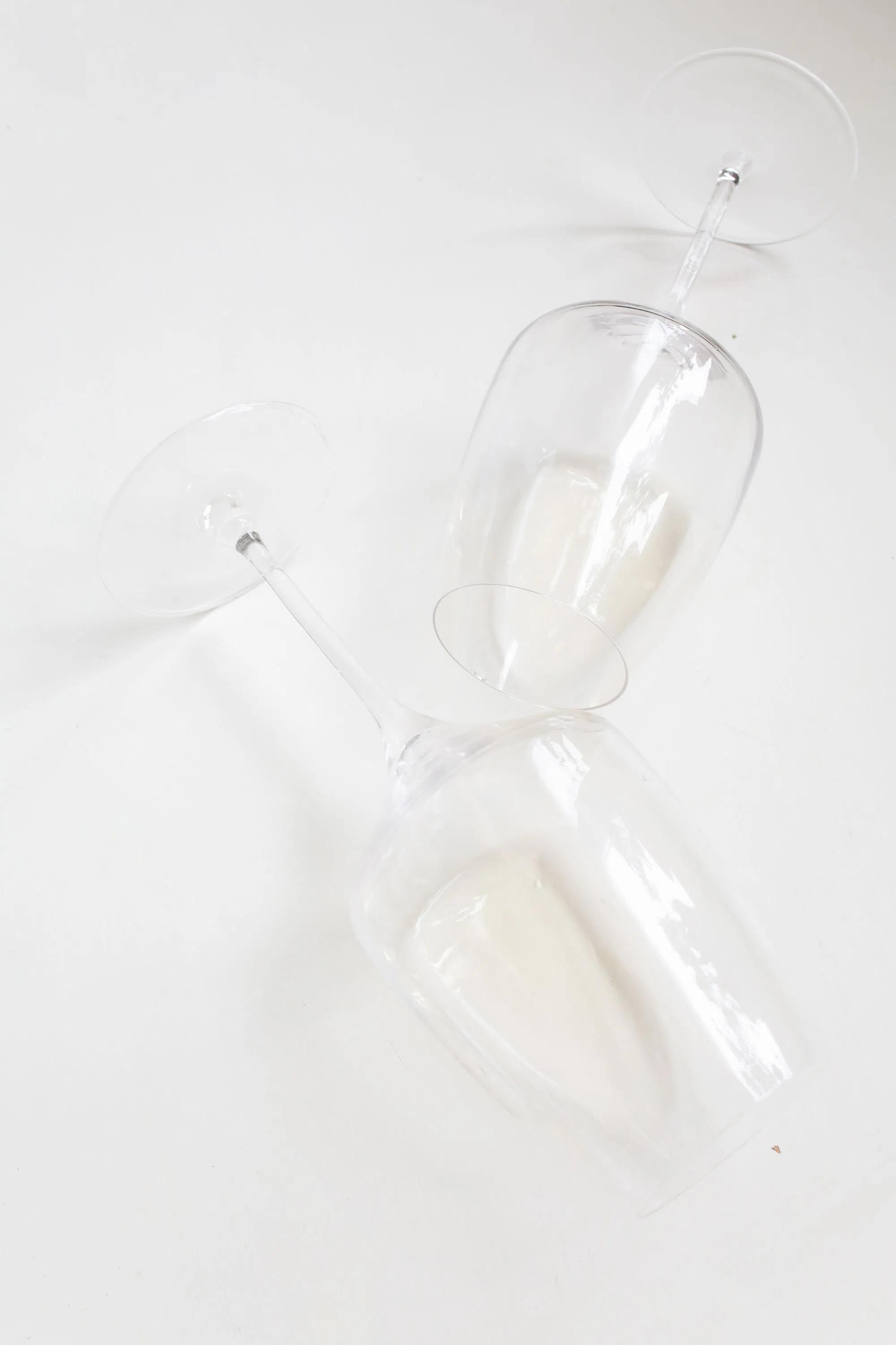 Clean, empty wine glasses on a white surface