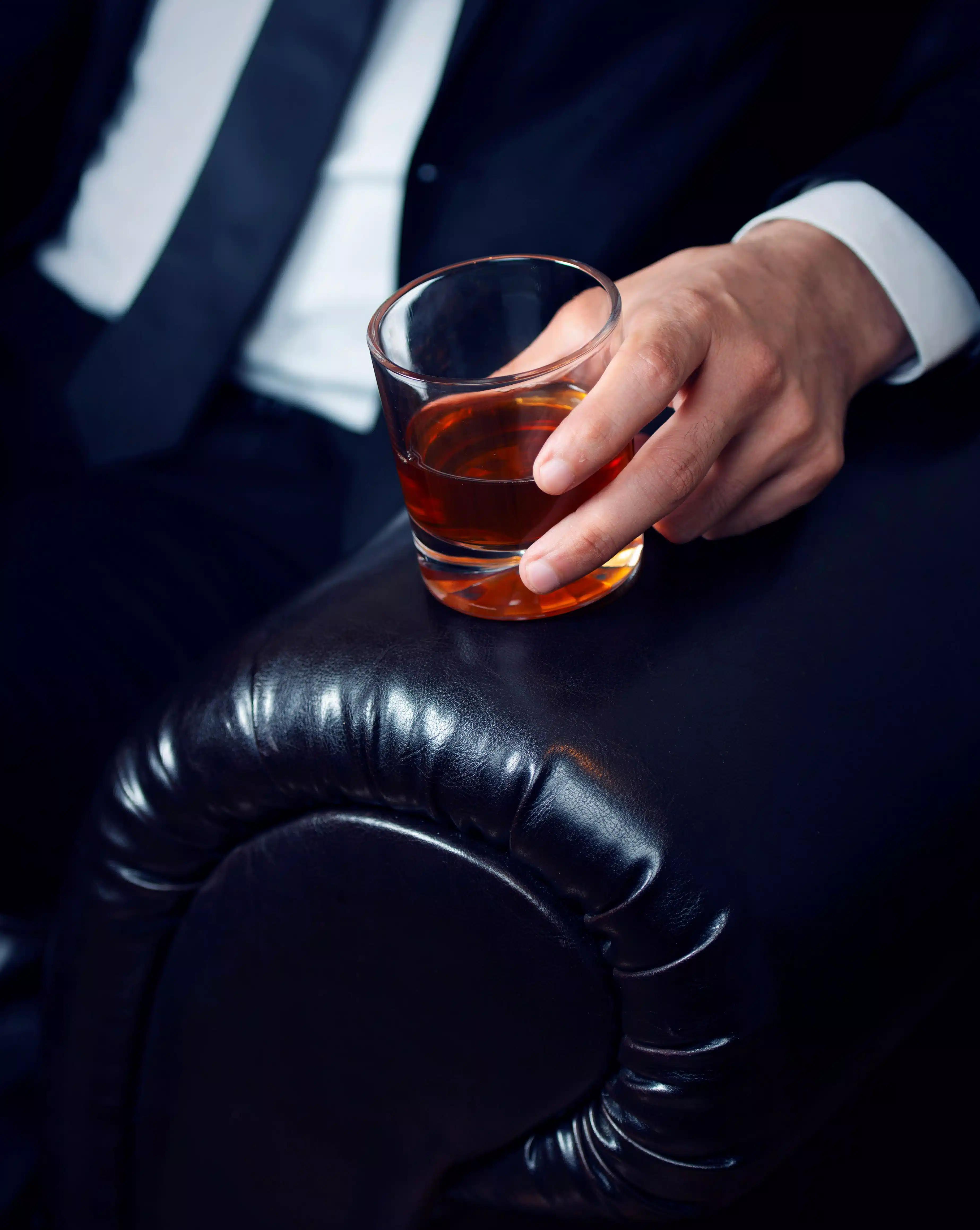 Man holding a whiskey tumbler