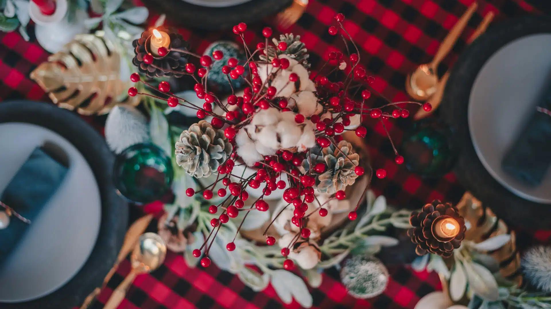 A closeup shot of a festive Christmas table setting centerpiece in red color palette