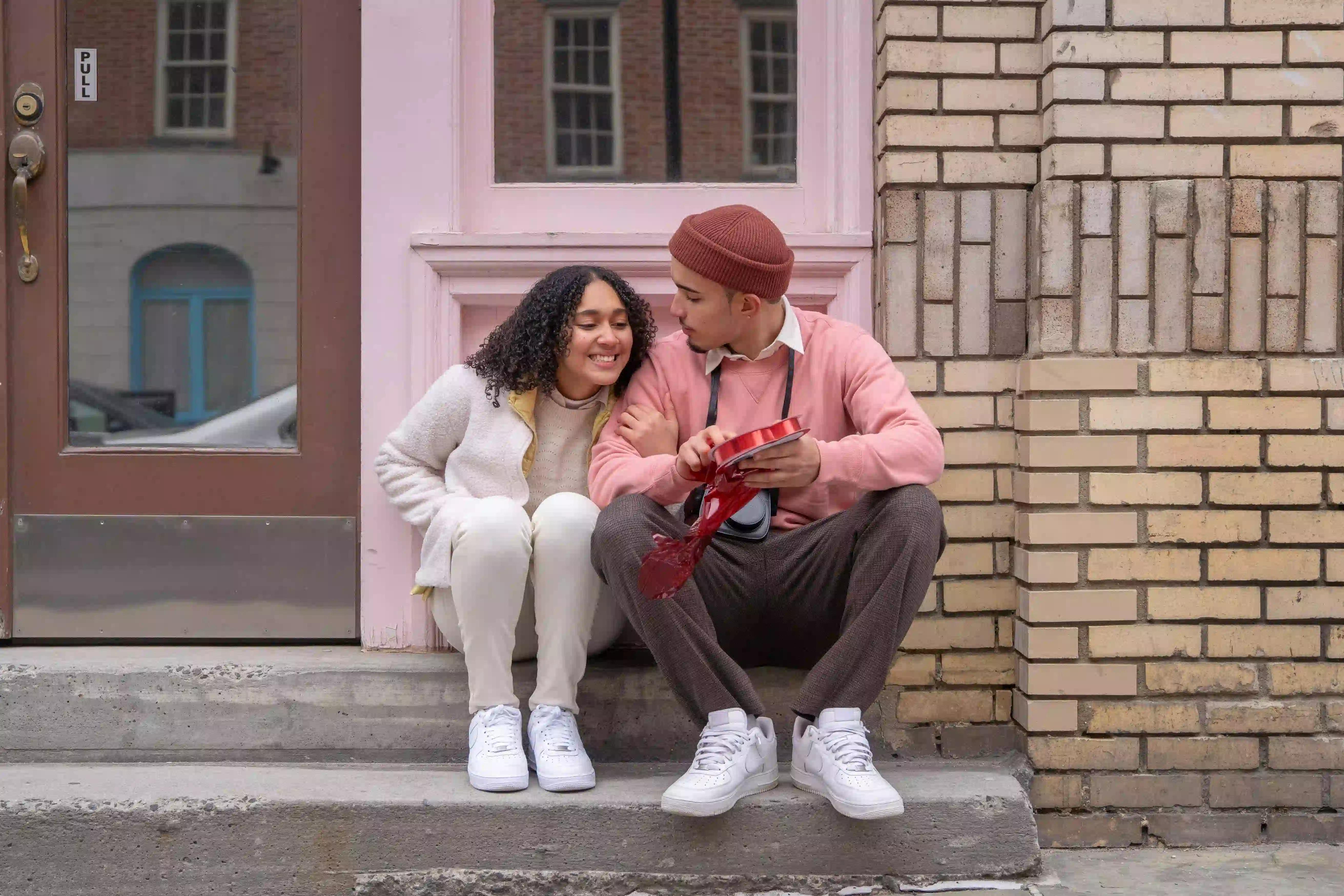A boyfriend and girlfriend sitting together