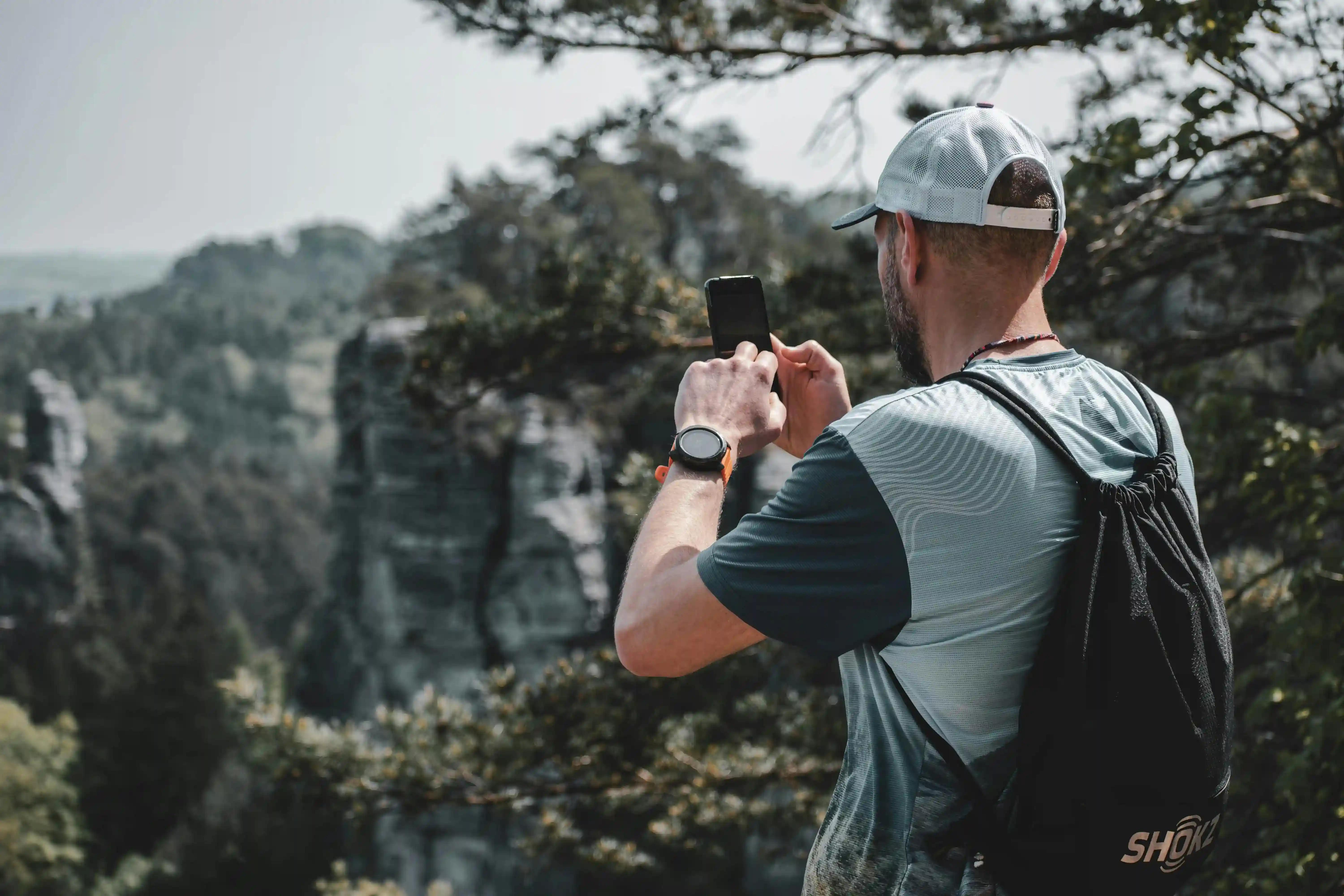A man outdoors using his gadgets