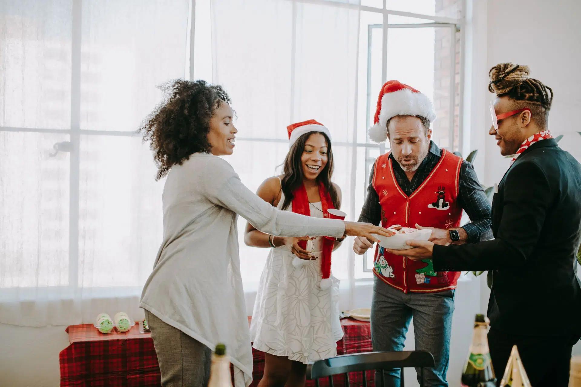Colleagues exchange gifts at a joyful office Christmas party