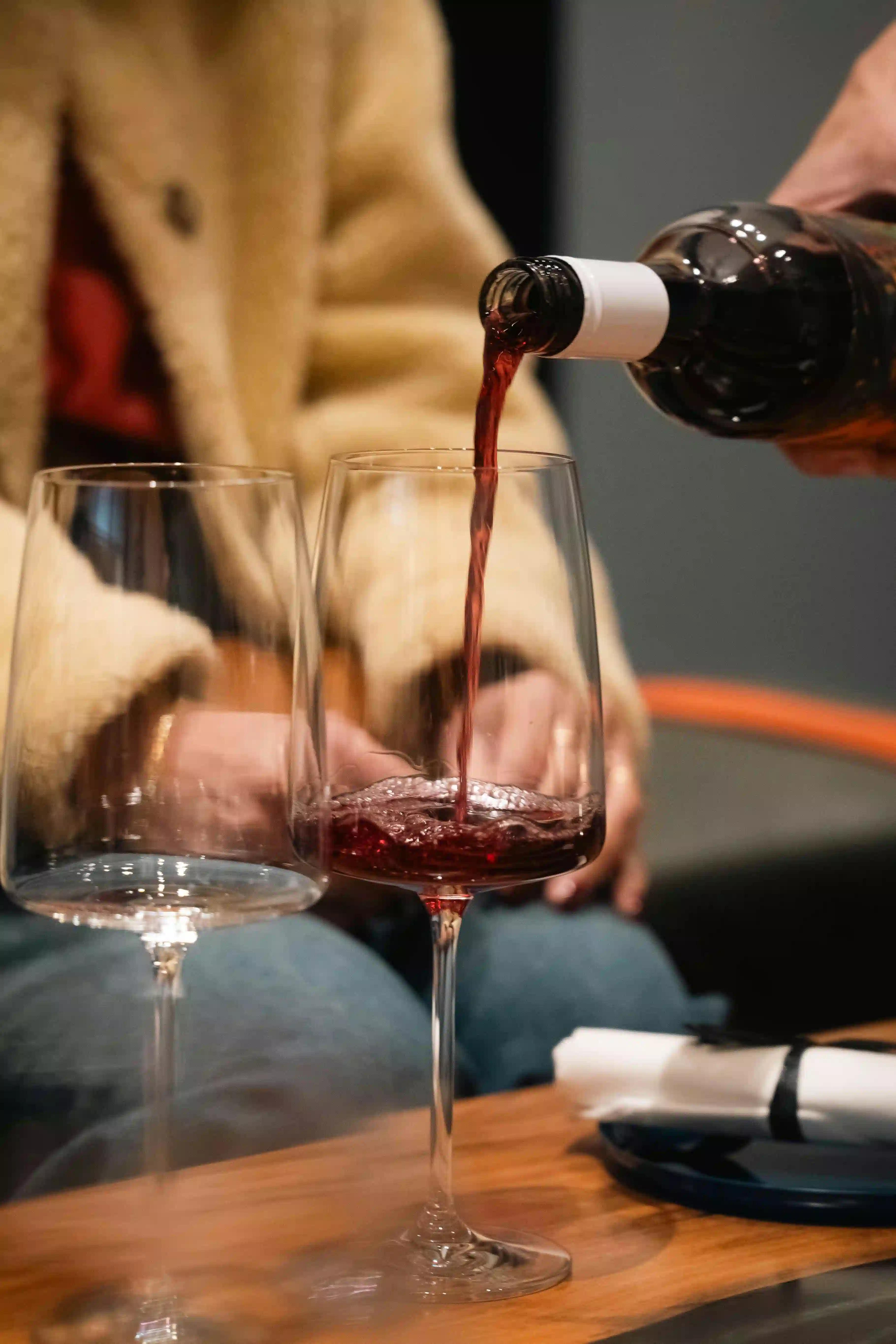 Red wine pouring into a wine glass
