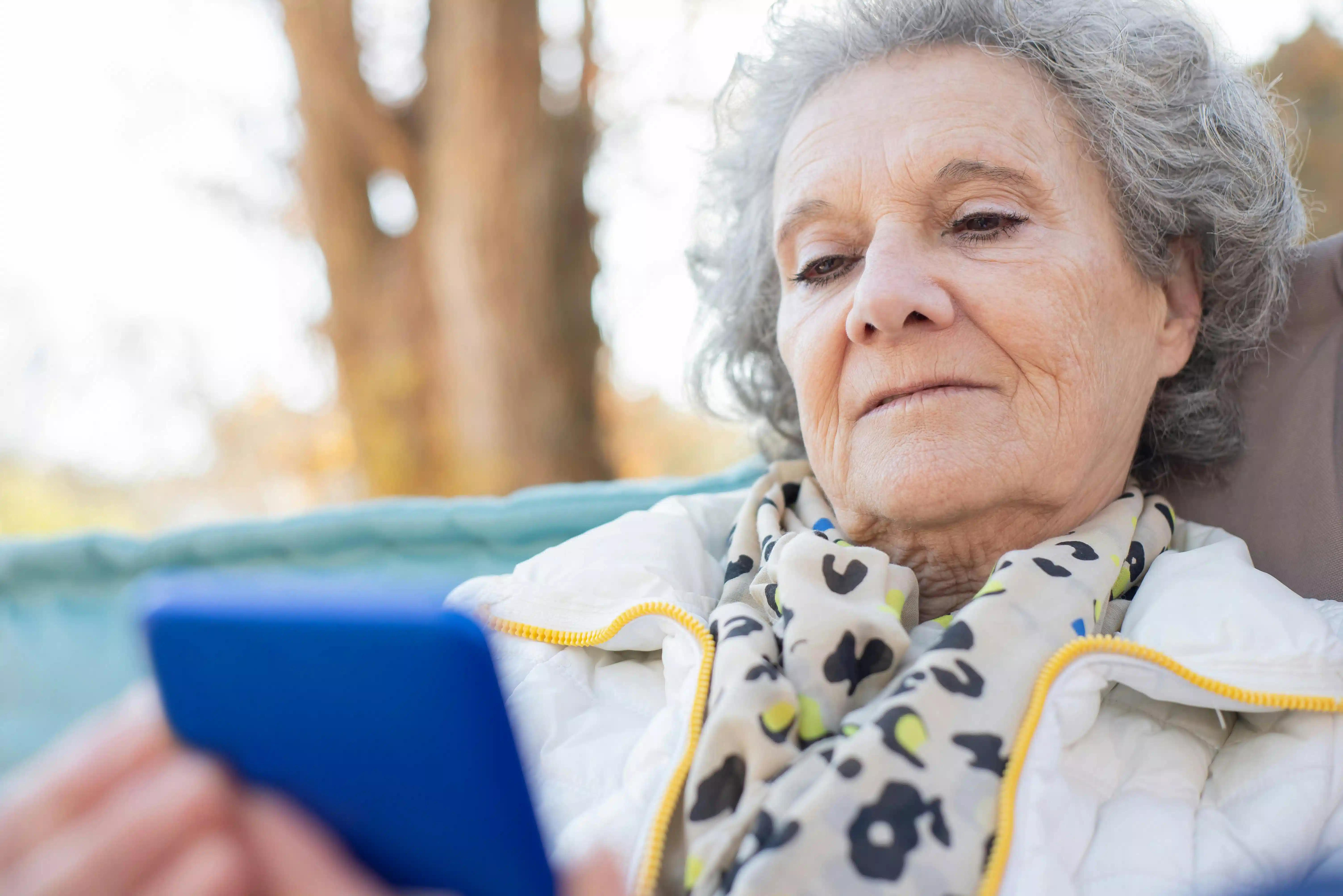 An older woman using an e-reader