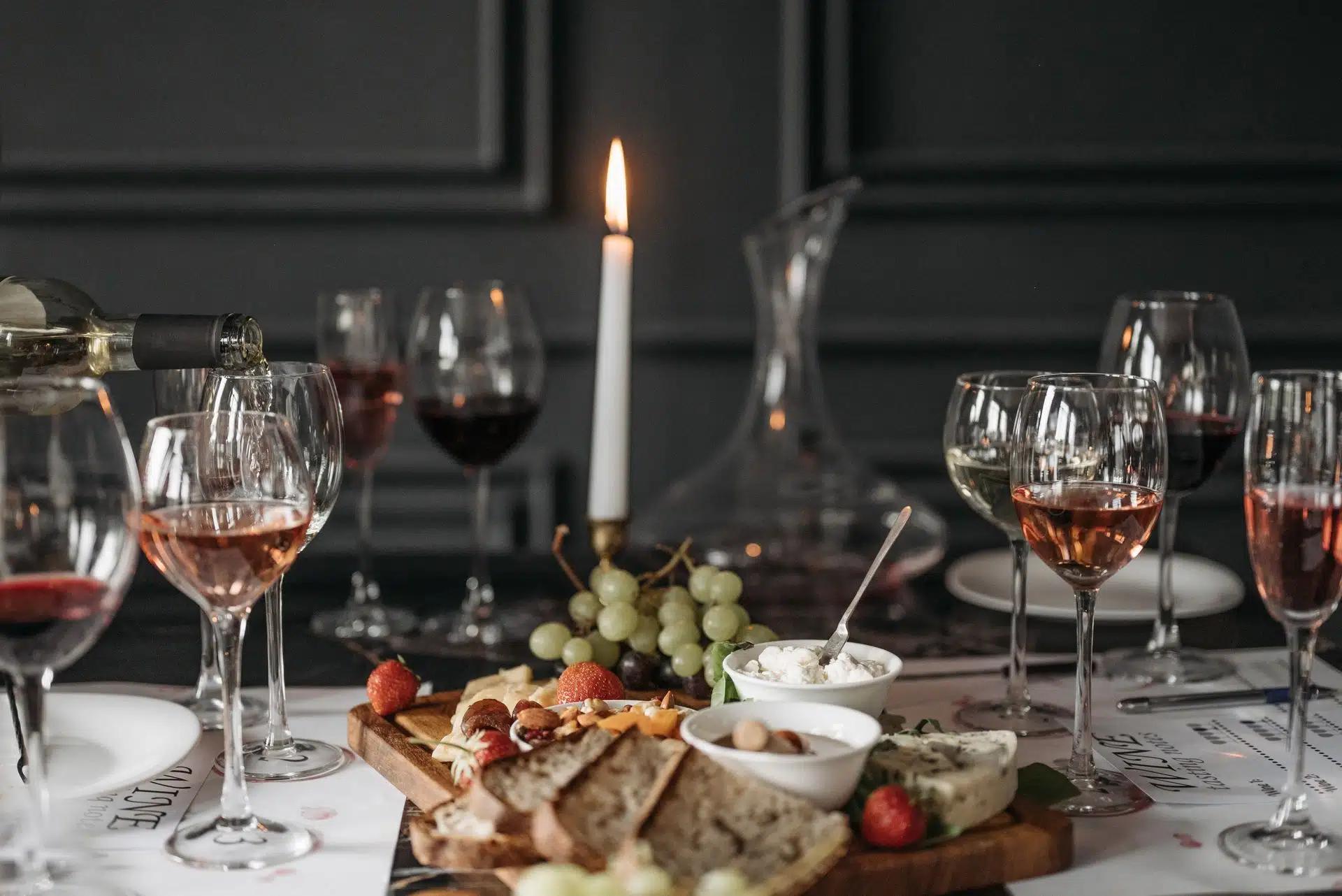 Sophisticated indoor wine tasting setup with cheese, fruits, and candlelight for a cozy atmosphere