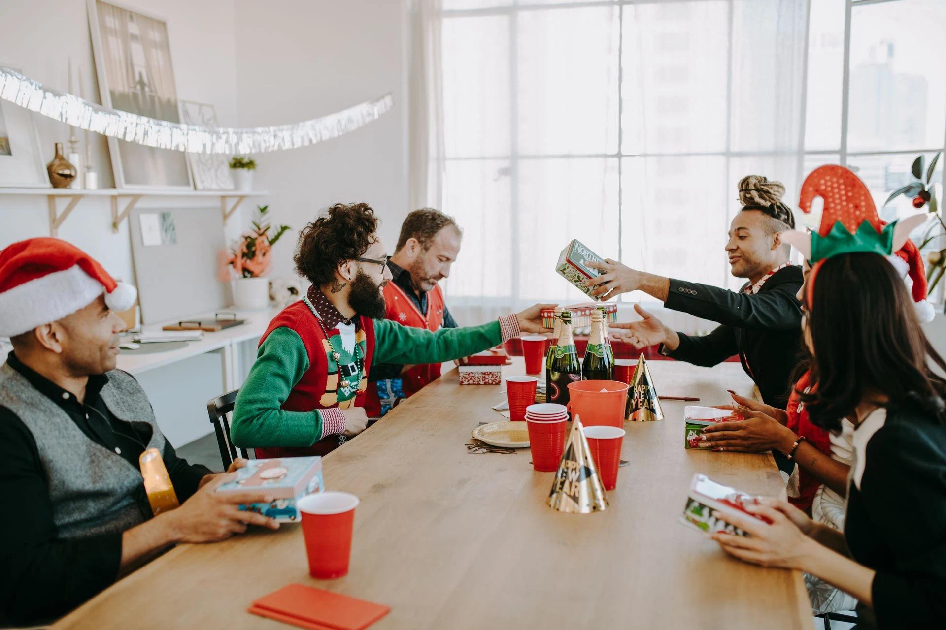 Officemates exchanging gifts during an office Christmas party