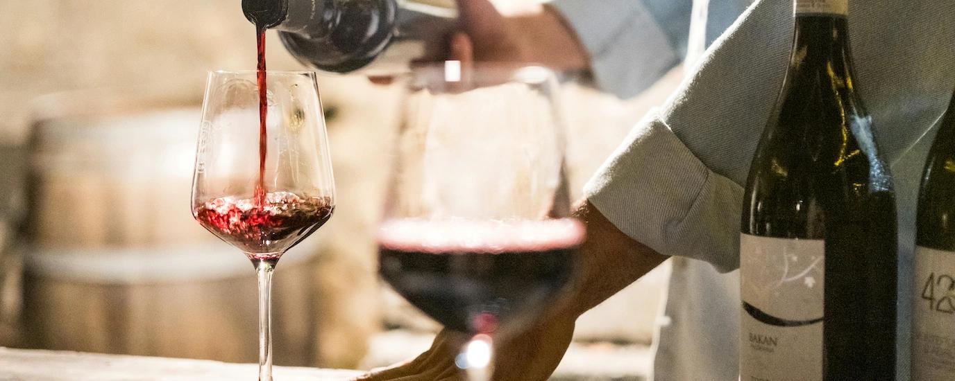 Red wine being poured into a wine glass