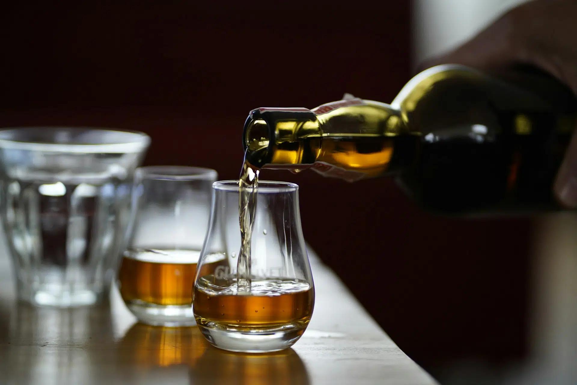 Whiskey being poured into a tasting glass