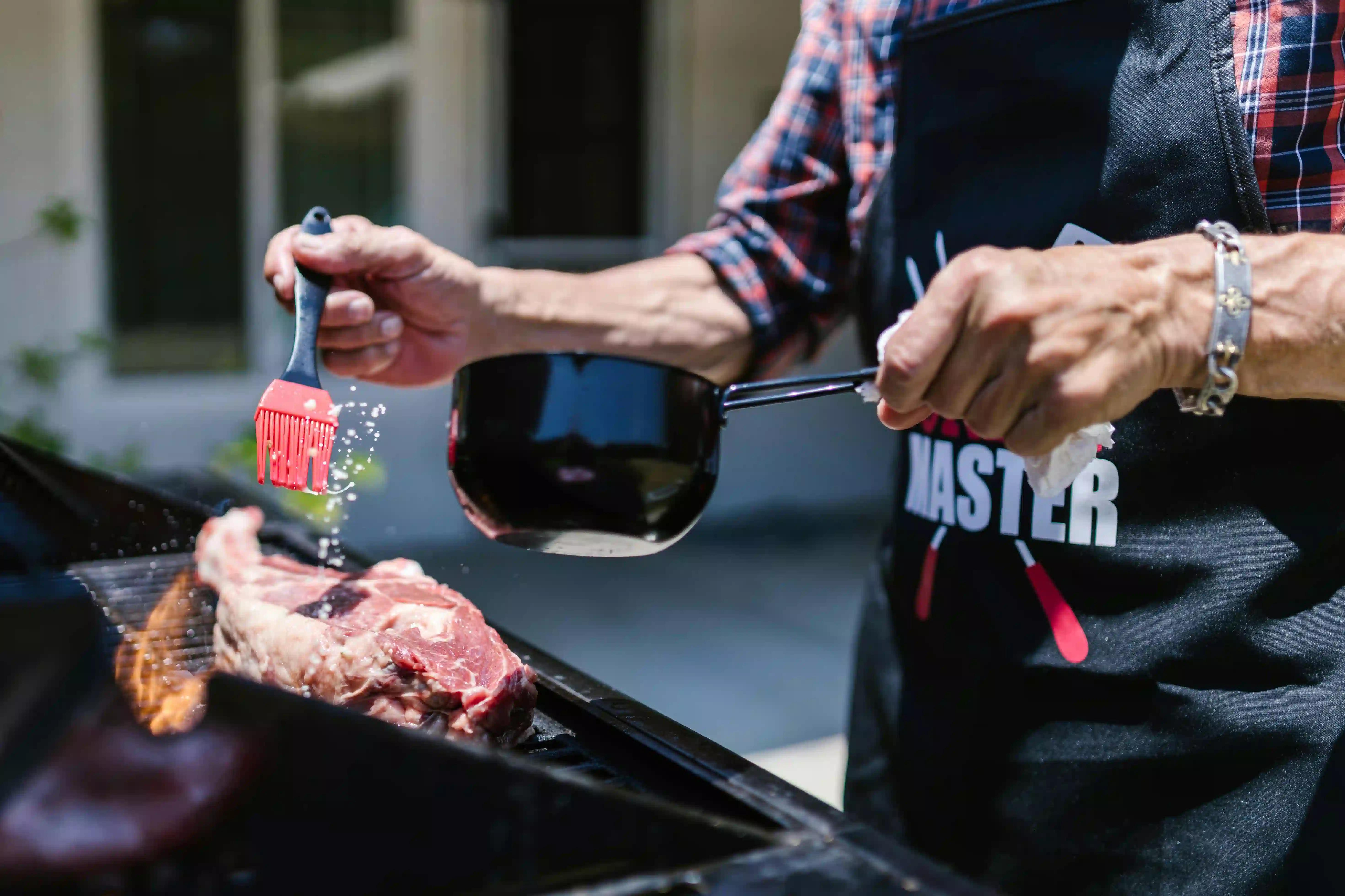 A man grilling in his backyard