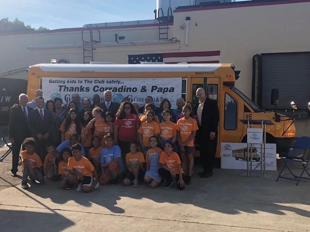 Image Corradino and Papa School Bus Donation Sitting Group Photo