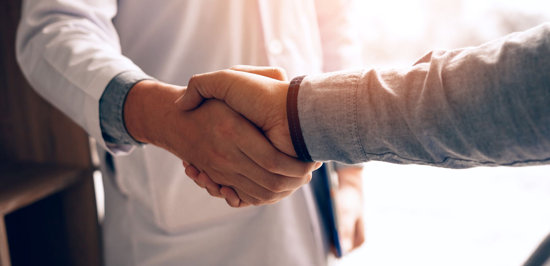 Doctor and patient shaking hands.