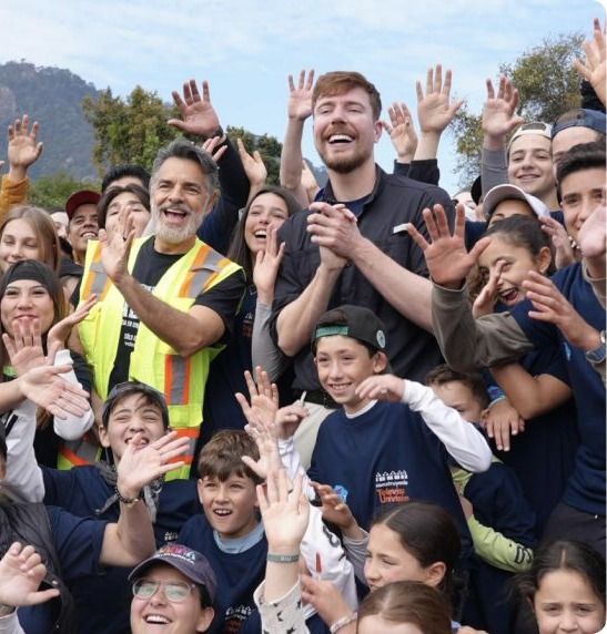 MrBeast with a crowd of the community the work serves