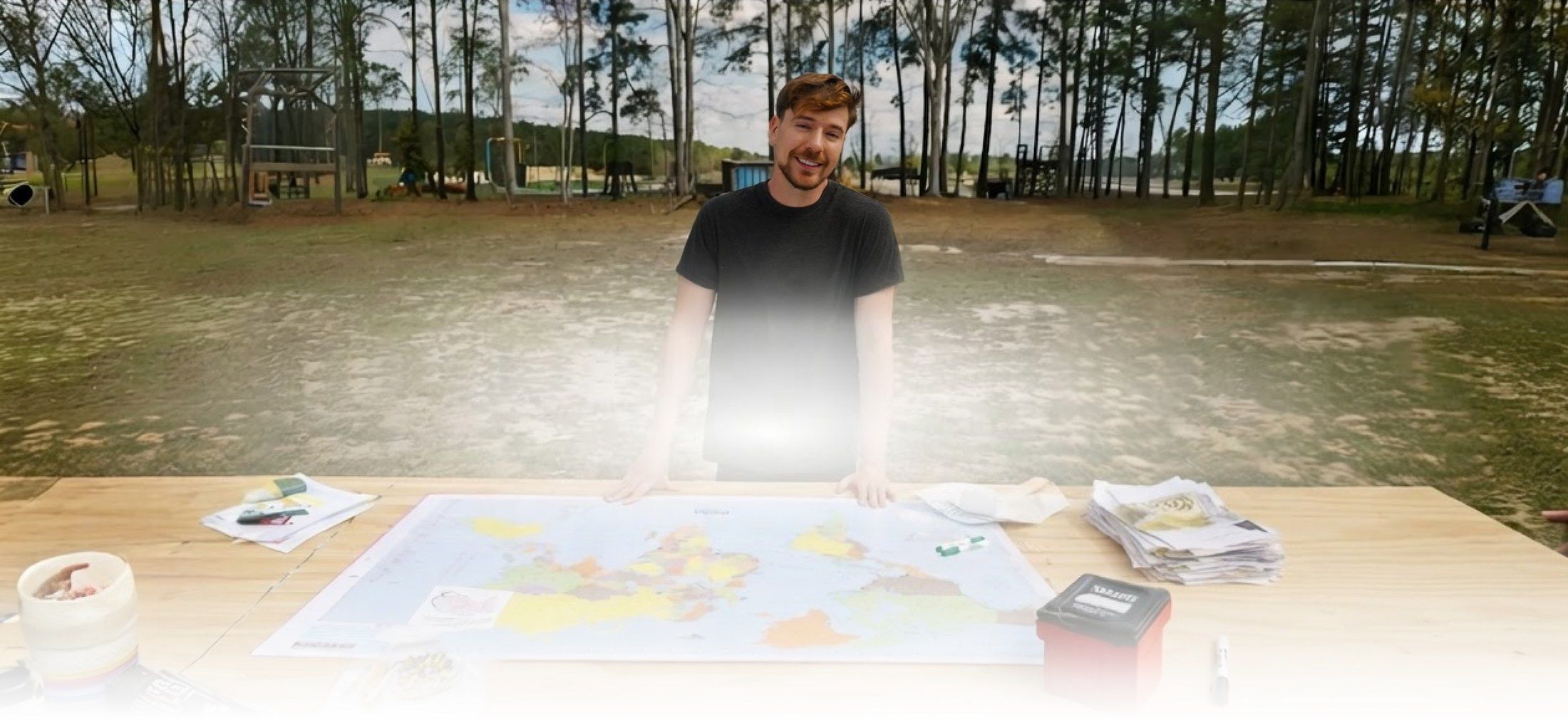 Jimmy Donaldson planning Beast Philanthropy projects over a world map