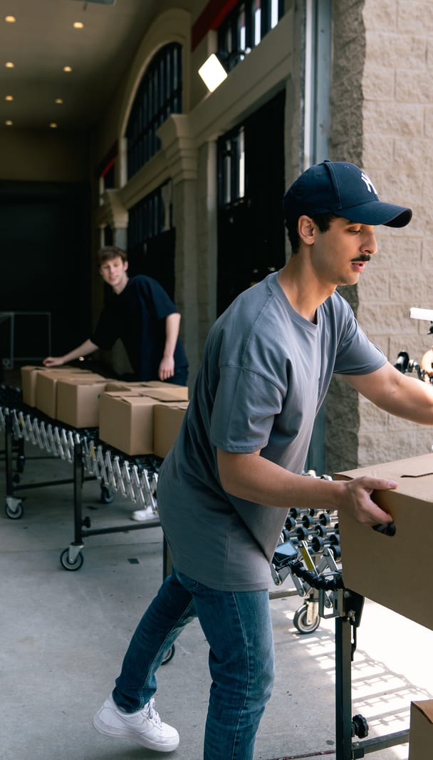 Boxes of food wheeled in on a dolly before a distribution
