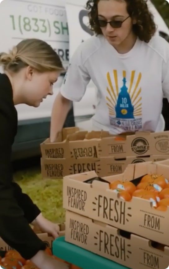 Volunteers packing produce boxes at the Beast Pantry