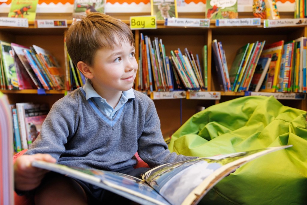 A little boy holding a book 