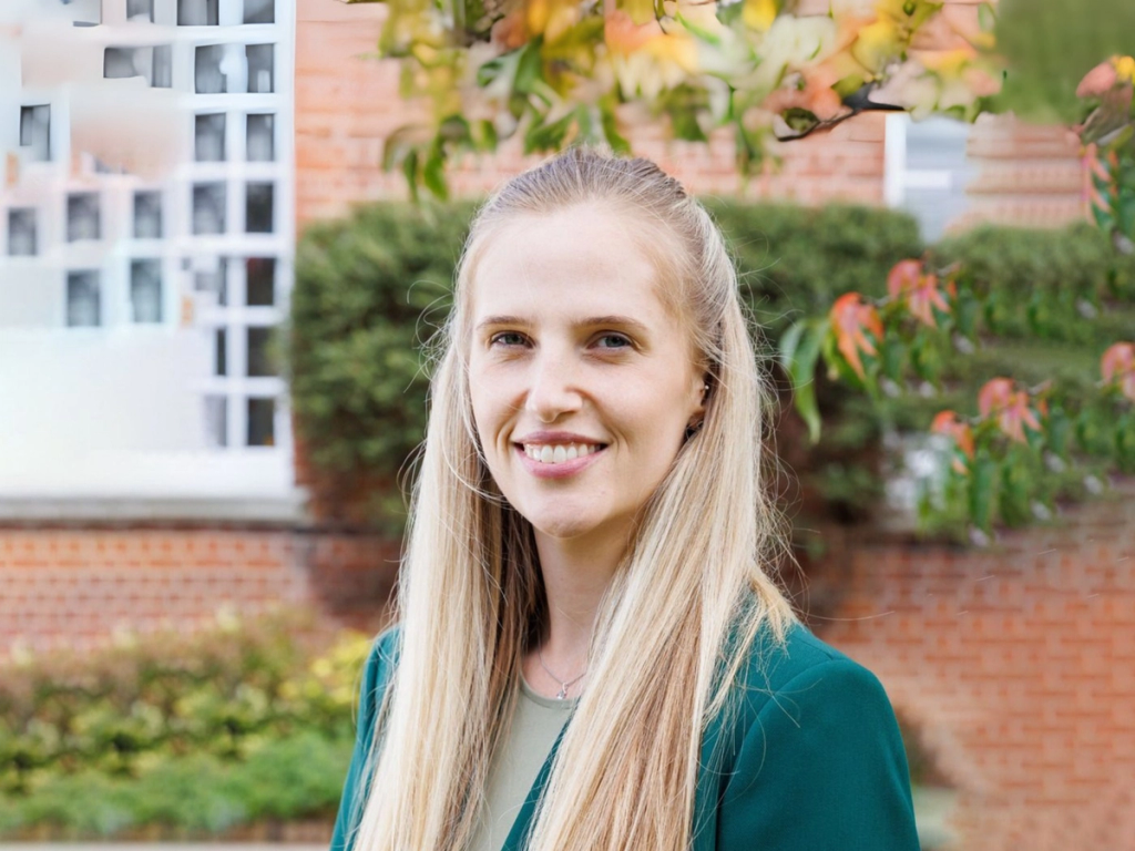 Portrait of the Senior Deputy Head at Mill Hill School, smiling outdoors in a professional headshot.