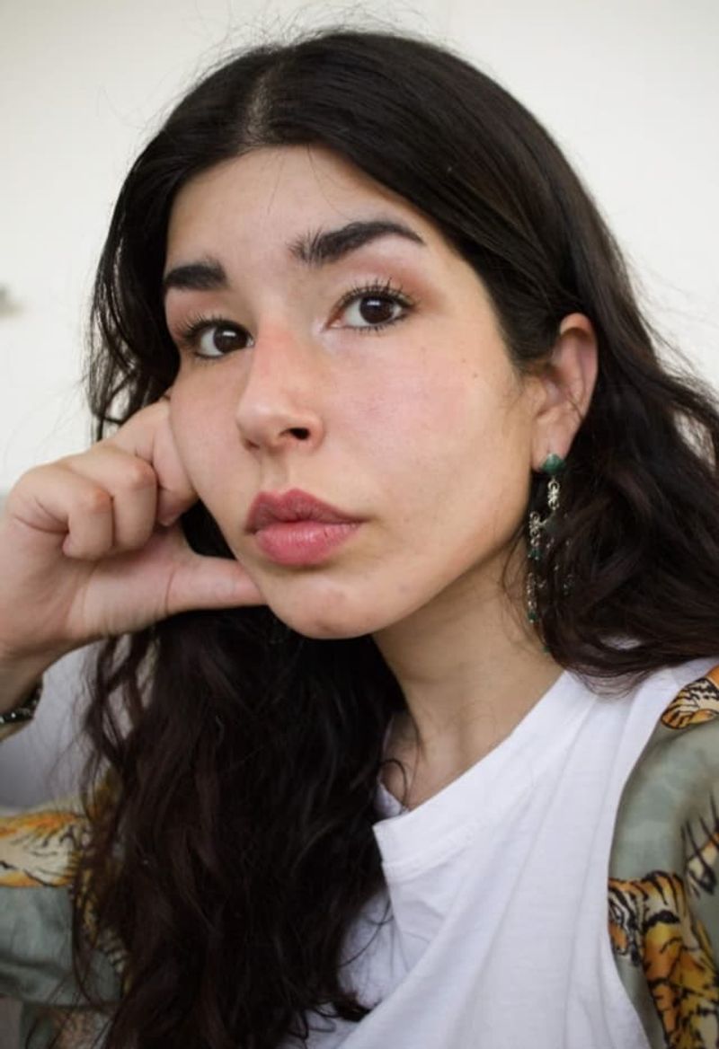 Ananya has black hair, earings and tigers on her shirt