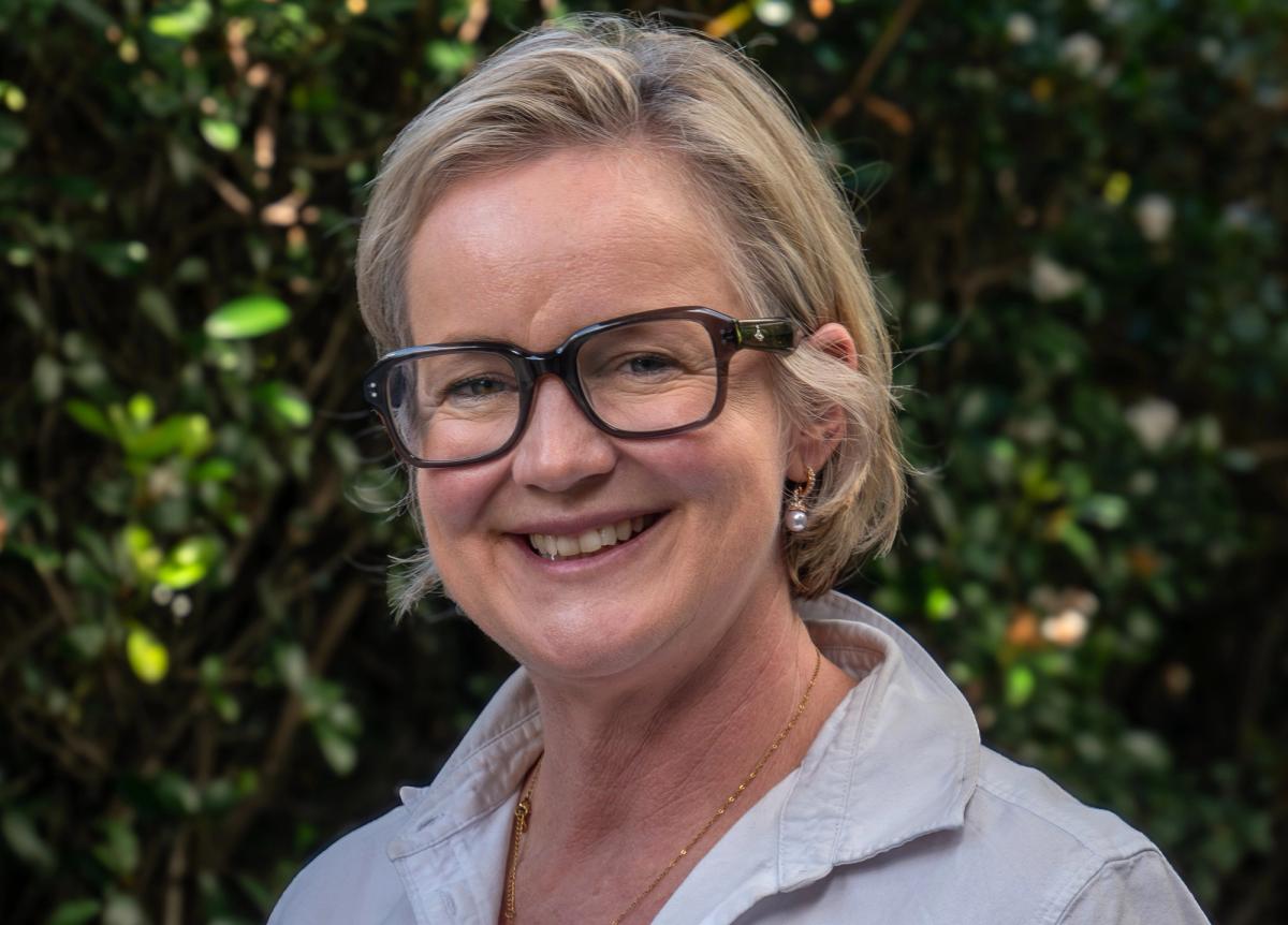 Jac smiling in the sun with glasses on