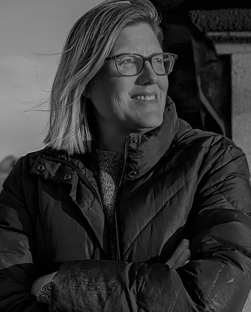 Meredith smiling with glasses and a warm winter coat