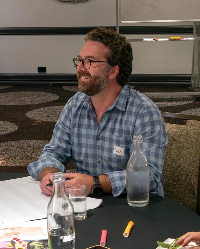 Josh smiling in a workshop