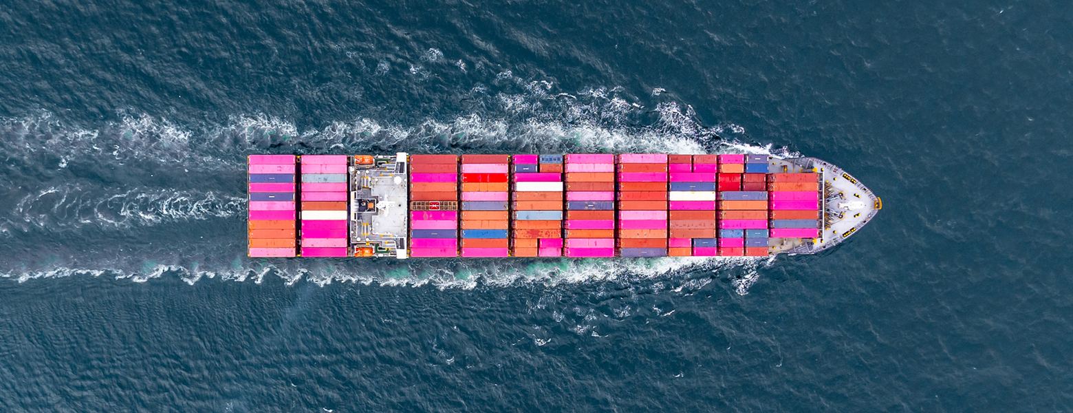 An aerial view of a loaded container ship under way at sea