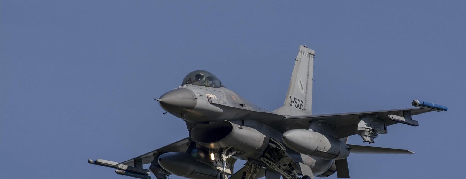 An F-16 fighter jet in flight against a clear sky