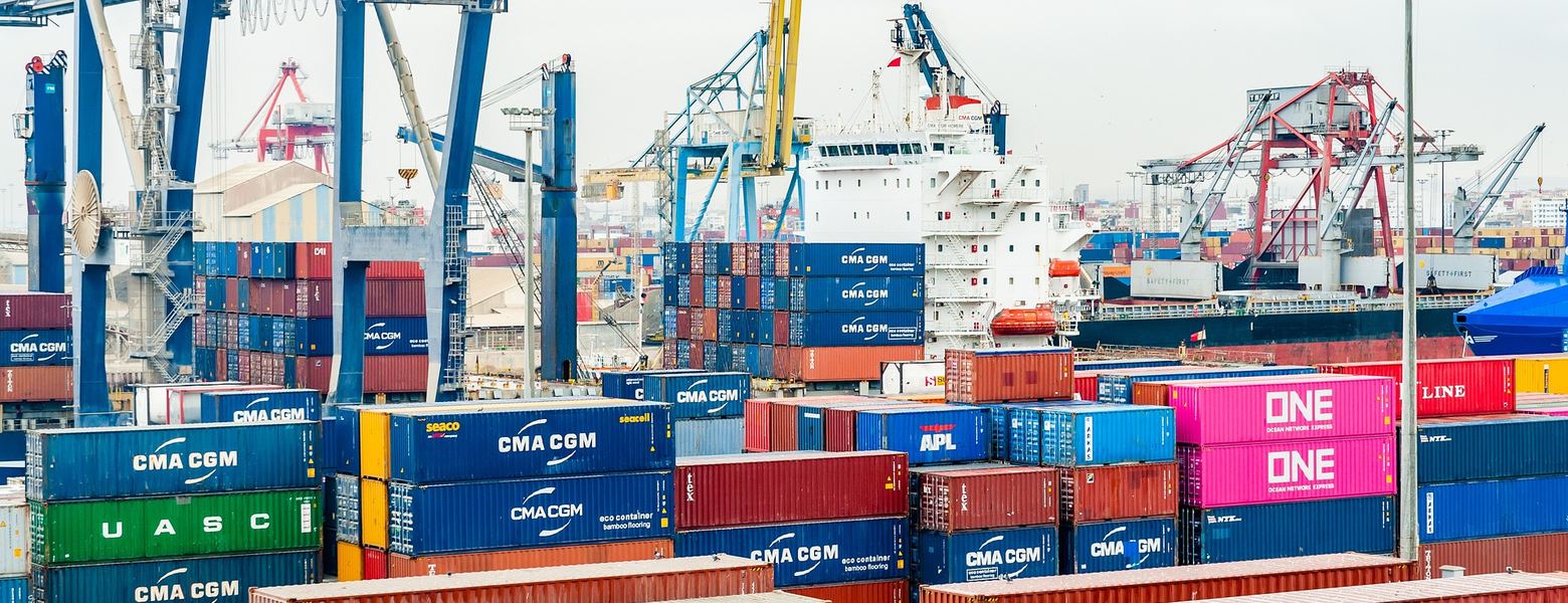 Shipping containers and cranes crowding a working port