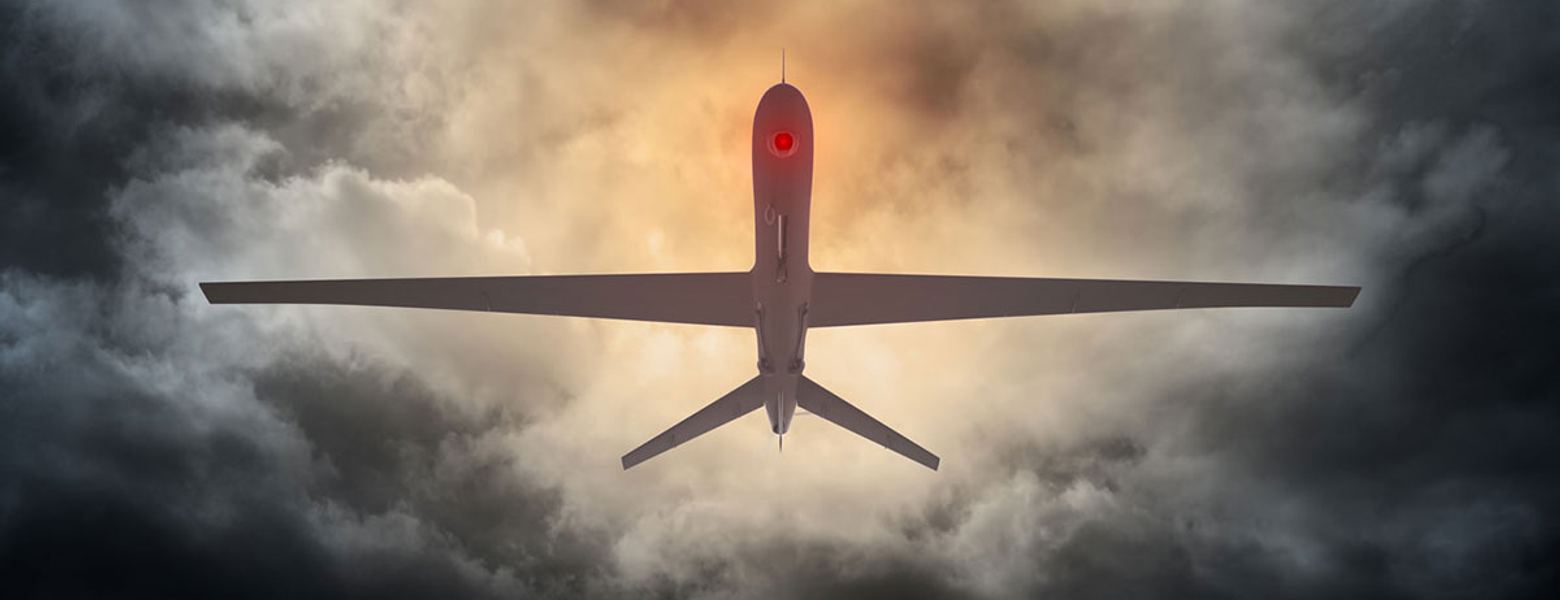 A military drone flying above heavy cloud