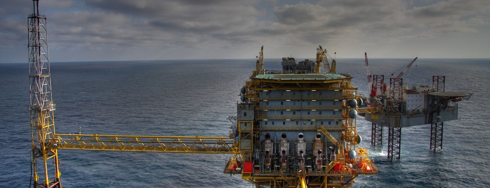 Offshore oil and gas platforms connected by walkways in open sea