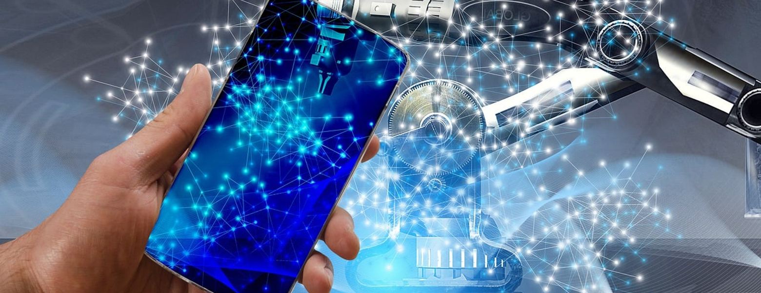 A hand holding a phone showing a network graphic, with a robotic arm behind