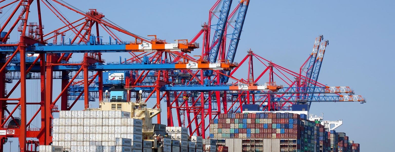 A container ship being worked by gantry cranes at a port