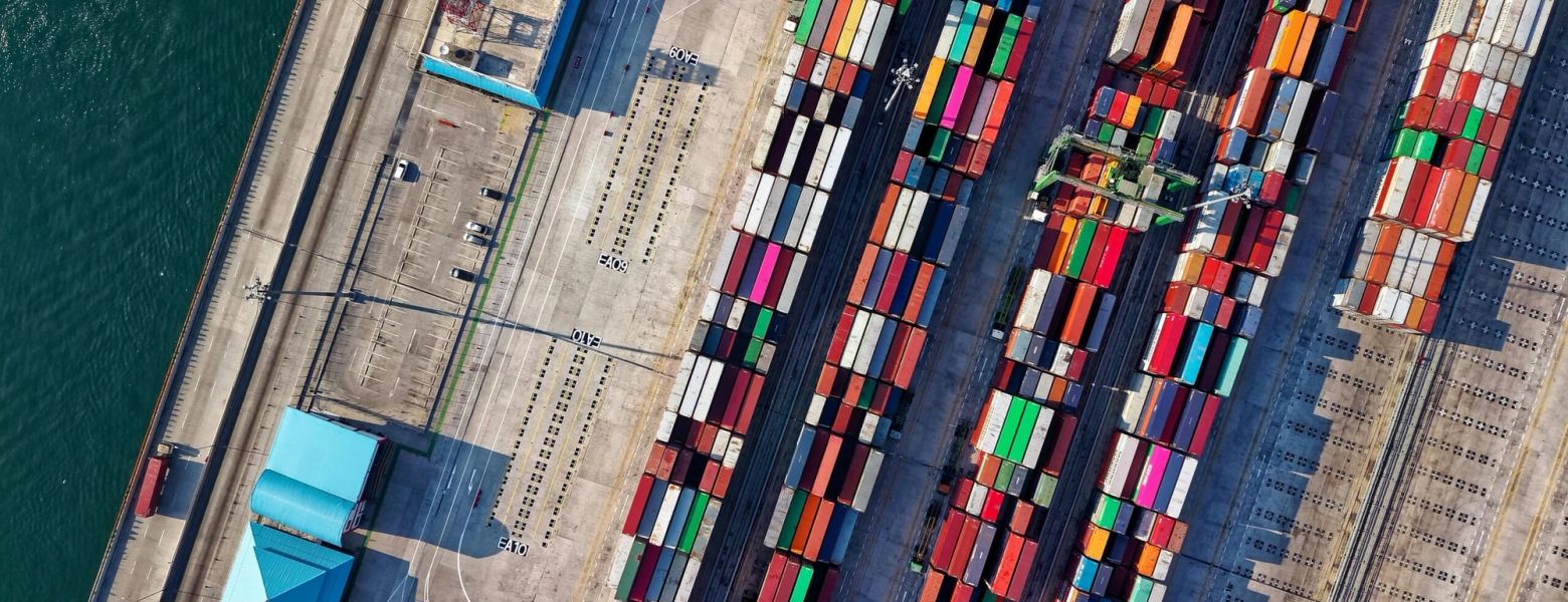 An aerial view of a container terminal with rows of stacked containers