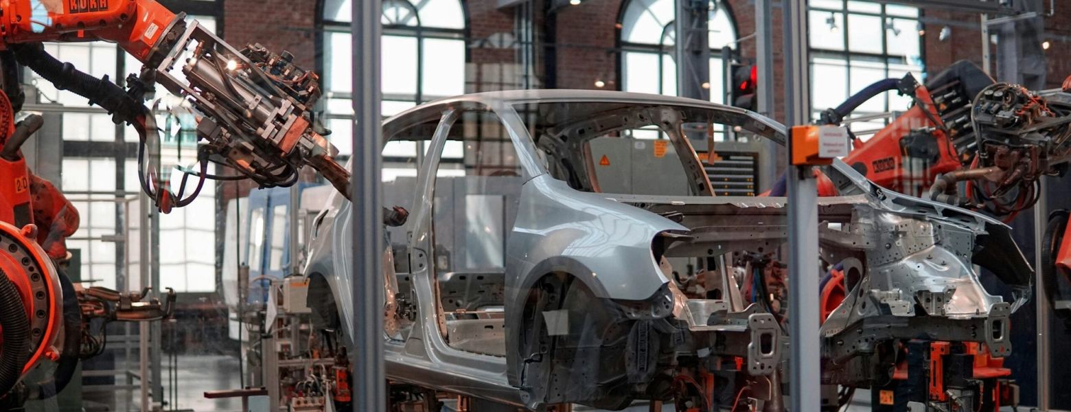 Robotic arms working on car body shells in a factory