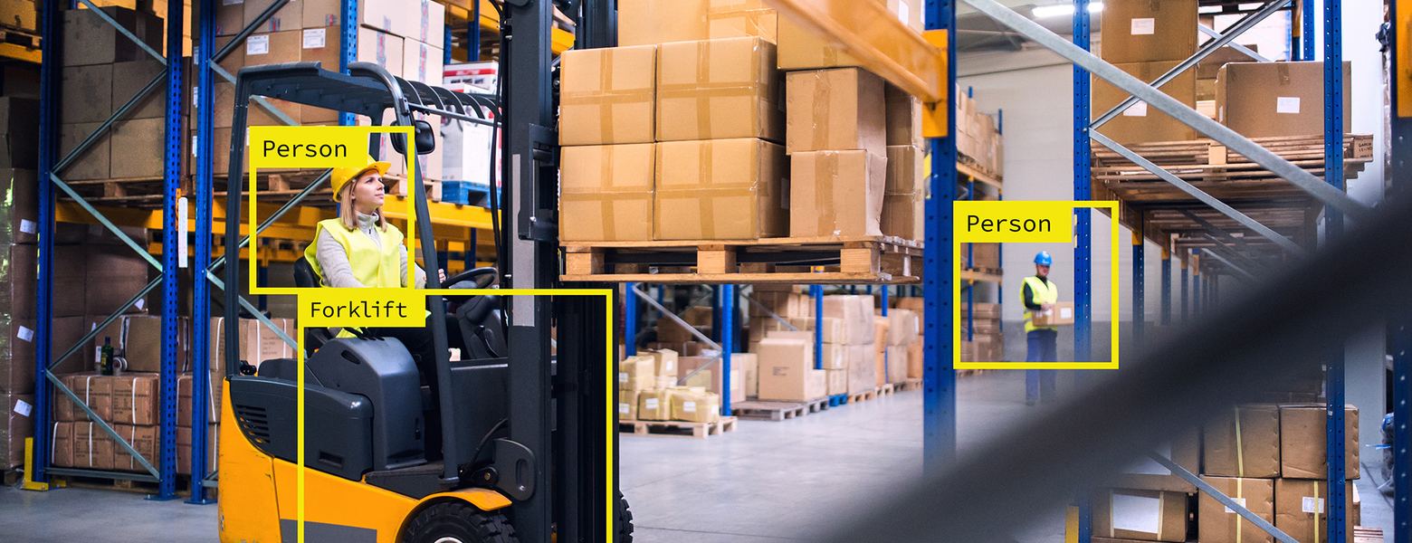 A warehouse scene with computer vision boxes labelling a forklift and two people